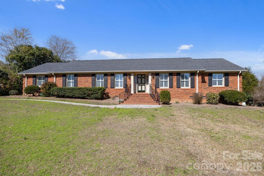 Beautiful all-brick ranch located in the desirable Ashley Park Golf Community at Kings Mountain Country Club! This spacious 4BR/3BA home offers an ideal blend of comfort, functionality, and style. The open kitchen features a gas cooktop, double ovens, and a custom coffee bar, flowing seamlessly into formal living and dining areas and a large family room with gas log fireplace. The expansive primary suite boasts wood floors, dual vanities, granite countertops, a walk-in tile shower, and his/her closets. Enjoy year-round relaxation on the 3-season covered porch with EZ Breeze system (2023). A private in-law suite includes a full bath, second kitchen, and separate entrance - perfect for guests or multi-generational living. Additional highlights include a new wired workshop, abundant storage, 2-car carport, and beautifully landscaped lot. Major updates: HVAC (2023), newer roof (+/-2020), tankless water heater, whole-house water purifier, and security system. Conveniently located near Kings Mountain Casino! No HOA!