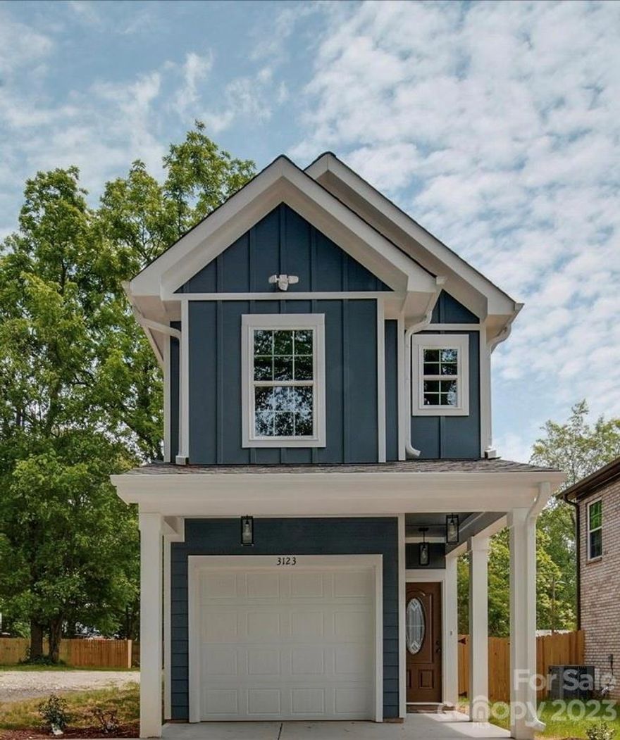 Check out the new construction happenings at Reid Park and surrounding areas, perfectly situated between Uptown, Southend and the proposed River District only 15 minutes away. Why buy a townhome with an HOA fee when you can buy a single family home with a yard and a 1 car garage. Enjoy your private garage with entrance into your home.The main level has an open concept with the kitchen, living room, dining area and 1/2 bath. Upstairs you will find the primary bedroom along with 2 other bedrooms and the laundry room. Some of the extra features you will find are: LVP throughout the main floor, wood cabinetry with soft close drawers, recessed lights, upgrades light features, moldings, granite countertops, lots of windows for amazing natural light and sliding glass doors outside to your private yard with oversized patio. Did I mention you have a level spacious lot perfect for those bbq's and it is fenced! Fence line that borders the property belongs to 3125 Reid