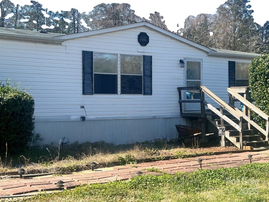 Lots of privacy on over 2.5 Acres. Huge wrap around deck. Nice size kitchen and great room. Large laundry room. Bathroom have heated flooring. Add your own touch to make this your home. Circle drive and a carport outside. Whole house generator. A few sheds are included.