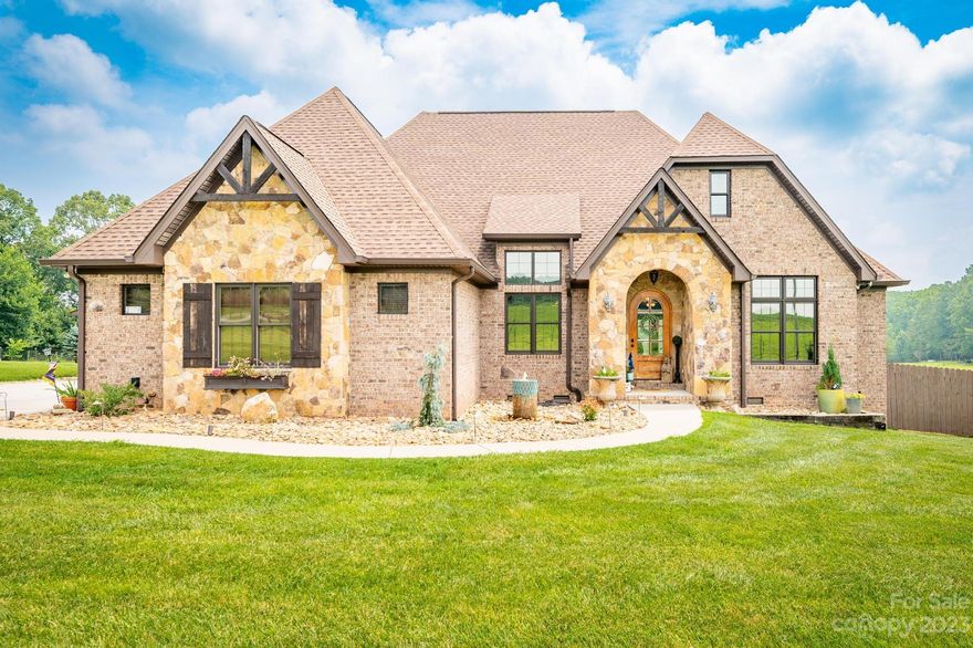 Welcome to this gorgeous countryside estate. Nestled on almost 8 acres, this property has endless features & possibilities. The stone & brick elegant main house boasts luxury finishes, 3 bedrooms, 3 full baths, 2-car garage, sprawling covered back porch, and a beautiful inground pool. You'll be delighted to find a 2-story guest house that has its own carport and two separate apartments in it, making it perfect for rental income or guests.The second full-brick smaller home features 2 bedrooms, 2 full baths, a car port, and a quaint covered porch.The huge barn has over 2,100 heated square feet, a covered side terrace, two bathrooms, and is set up perfectly for an event venue. (google Barn 76 for more info). Bring your farm animals to enjoy the fenced pastures, the large chicken coop with tons of additional storage space, and the second smaller barn. You'll also love the outbuilding that can store up to 5 tractors/vehicles and a detached "small gym" building.This estate TRULY HAS IT ALL!