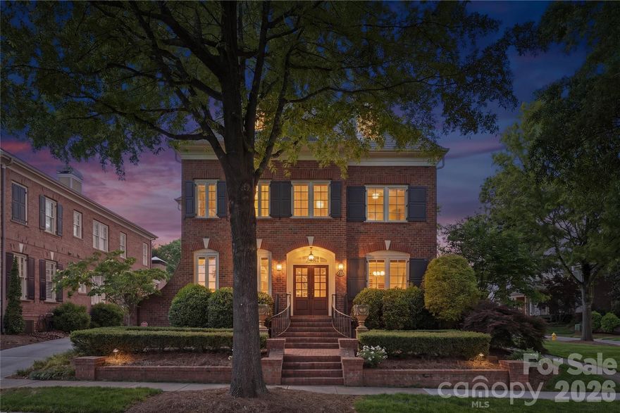Simply stunning Simonini Builders full-brick residence in the gated Heydon Hall community, ideally positioned in the heart of SouthPark. Thoughtfully designed with refined finishes, the home offers 10-foot ceilings on the main level and hardwood floors throughout. The kitchen is both functional and beautifully appointed, featuring expansive quartzite countertops, floor-to-ceiling cabinetry, a built-in china cabinet, and a walk-in pantry with custom shelving. Premium appliances include a Thermador double oven, a Thermador gas cooktop with griddle with a Themador range hood above, and a Thermador microwave, along with a GE Monogram dishwasher. A recessed pop-up outlet in the oversized island and powered shades in the breakfast area add convenience. The kitchen flows seamlessly into the main living space, where a lighted tray ceiling, marble-surround fireplace, and custom built-ins create a warm, polished setting. Formal dining connects via a butler’s pantry with a GE Monogram wine refrigerator for easy entertaining. A dedicated office on the main level includes a full bath and solid pocket doors, offering flexibility as a private guest suite. The laundry room is also on the main level and includes a utility sink and a built-in drop zone with four individual storage areas, complete with drawers, hooks, and cubbies. Upstairs, the primary suite features a lighted tray ceiling, detailed moldings, and a spacious layout. The ensuite bath is finished with marble flooring, a soaking tub, dual vanities with marble countertops, and a separate tiled shower. The custom walk-in closet is designed for organization. Three additional bedrooms complete the second level—two connected by a Jack and Jill bath, and one with its own ensuite. The third level expands the living space with a full bath featuring a steam shower, a large recreation area suitable for media or game use, and a separate fitness space. A well-appointed wet bar enhances the level, complete with a GE Monogram beverage refrigerator, GE Monogram ice maker, and granite countertops, creating an ideal setup for entertaining. Outdoor living is equally considered, with double French doors opening to a covered patio with beadboard ceiling, paver flooring, a ceiling fan, and a privacy wall designed to accommodate a mounted TV. The outdoor kitchen includes a built-in Summit refrigerator and a dedicated grill area with a gas line, creating a functional setup for everyday use or entertaining. The flat backyard is enclosed by a combination of brick and metal fencing, offering both privacy and openness. A stepping-stone path leads to a secondary paver patio centered around a wood-burning fireplace with a gas starter. A detached two-car garage provides additional storage, epoxy flooring, and built-in cabinetry.