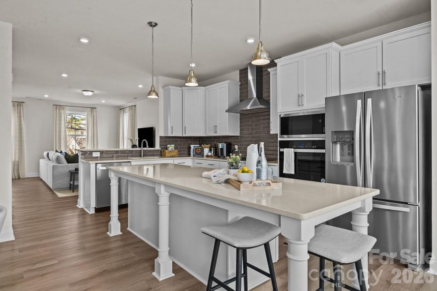 Welcome to The River District—a true master-planned community designed for the way you live, work, and play.

This beautifully appointed Landon three-story townhome offers exceptional flexibility and style. The main level features a guest bedroom as well as a full bathroom w/ a walk in shower.

Upstairs, the heart of the home shines with a gourmet kitchen showcasing quartz countertops, a built-in oven and microwave, electric cooktop, and soft-close cabinetry. The open-concept dining and living areas provide an inviting space for entertaining, with sliding glass doors leading to your private balcony—ideal for morning coffee or evening relaxation.

The third level hosts a serene owner’s retreat, complete with a bright and airy bedroom and a spa-inspired bath designed for ultimate comfort. Two additional bedrooms, a full bath, and a conveniently located laundry area complete the upper floor.

Every detail of this home has been thoughtfully curated, with interior design finishes individually hand-selected by our professional design team.

Location truly sets this home apart. At The River District, you’re just minutes from everything you need. The community will feature resort-style amenities including a pool, clubhouse with fitness center, tennis and pickleball courts, parks, scenic trails, a working two-acre farm with an on-site farmer, and a stunning riverfront amphitheater.

Experience elevated living in a vibrant community where convenience meets connection. Estimated completion: July