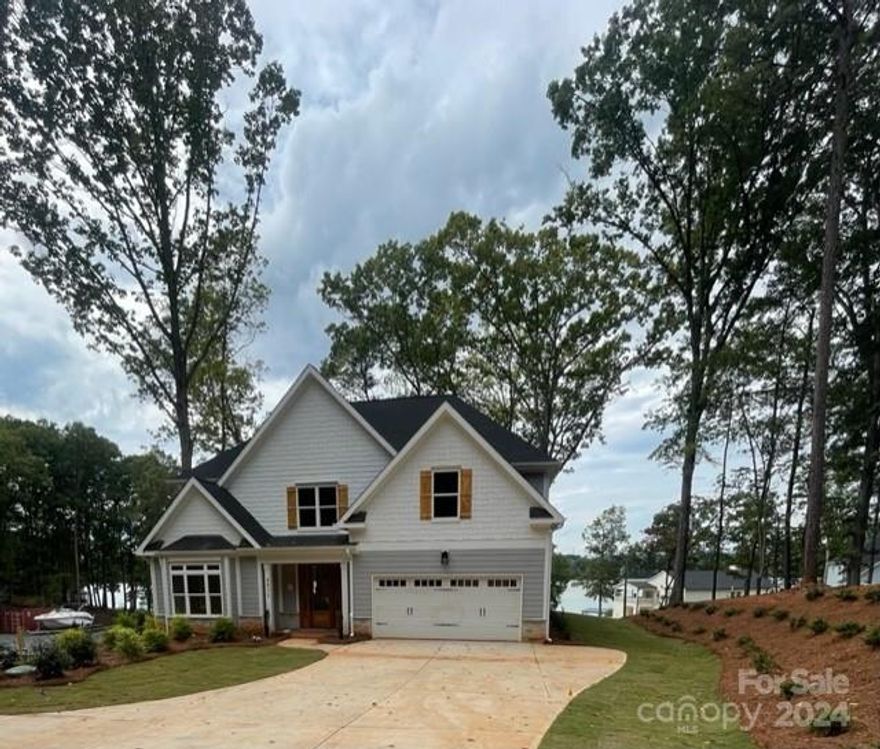 New Construction house on Lake Wylie. Enjoy breathtaking views from this house and from your new dock. There is a huge flat rear yard below the hill that is perfect for kids running around or playing lawn games. There is also an old road on the right side of the lot that allows you to drive an suv or golf cart down to the dock. 

The boat lift for the dock will be installed once a contract is written on the house so that it is custom fit for your boat. 

This house offers a gourmet kitchen with a custom vent hood as well as a wall mount microwave oven combo and a warming drawer below. This open floor plan is perfect for entertaining. The mahogany front door and 2 story foyer offer a warm welcome to any guests. The house offers custom site built closets throughout as well as an owners suite with a sitting room and a bathroom with a fully tiled shower and free standing tub.