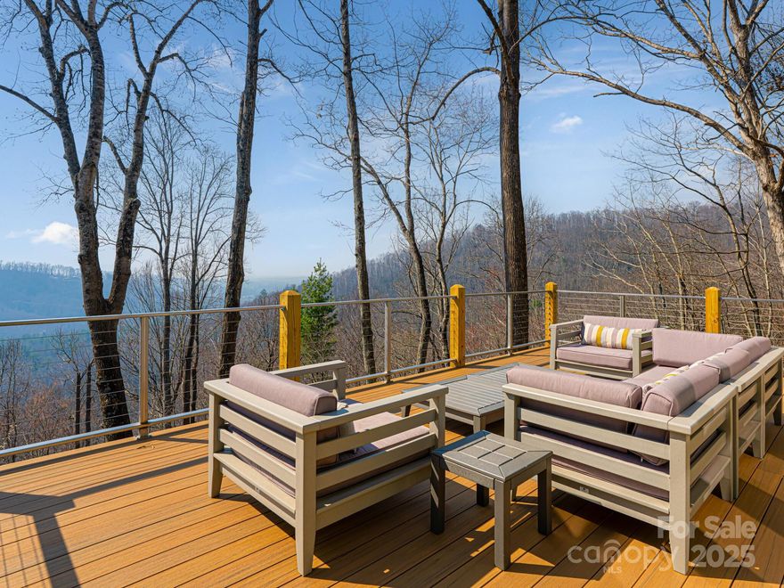 This charming luxury home in a quiet mountain community consisting of just 11 homes, offers an abundance of natural light with updated high end finishes and details. The kitchen, featured in North Carolina Home Magazine, is of birds eye maple and walnut stained cherry wood cabinetry. Top of the line appliances  include Sub Zero side by side, a six burner propane Wolf stove top and electric oven combo as well as a Miele dishwasher. The spacious interior features an open floor plan with panoramic mountain views from primary bed room, living room and kitchen.  Breathtaking unobstructed views of mountains from both the main level and lower level including the New decks cantilevered off the main level and lower level. This 4 bedroom 3.5 bath home has ample space for entertaining family, friends and guests. Located close to downtown's vibrant dining and entertainment options, this is mountain living at it's finest. 15 Minutes from the Asheville Airport.