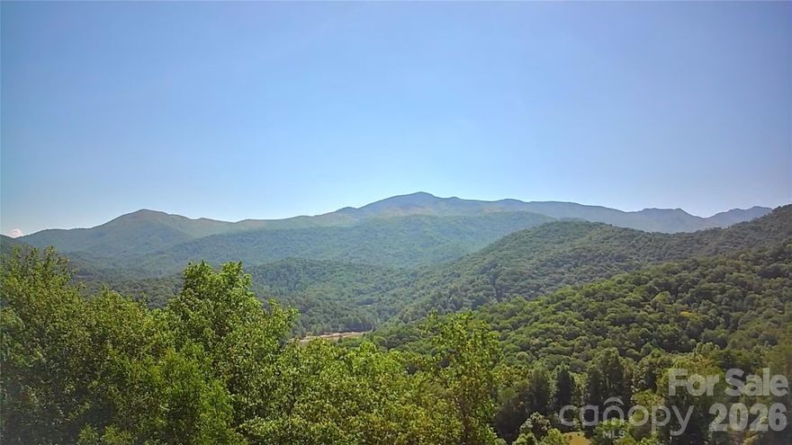 This mountain gem truly has it all — stunning long-range mountain views, gentle buildable land, peaceful surroundings, and an ideal location just minutes from town. Four adjoining lots are being offered together as one remarkable property, located just 15 minutes (7 miles) from the charming town of Burnsville.

Situated at over 3,000 feet in elevation, this beautiful mountain property features mostly level to gently sloping terrain with desirable southern exposure and the potential for breathtaking long-range views of Celo Knob and the Black Mountains. Convenient access from two well-maintained private roads provides both flexibility for building and added privacy within a peaceful mountain community.

A seasonal spring flows through the property, adding to its natural beauty and creating the potential for a unique landscape feature. Ideally located near the Cane River, this property is perfectly suited for a private mountain retreat, vacation getaway, or full-time residence with easy access, serene surroundings, and inspiring year-round mountain views.