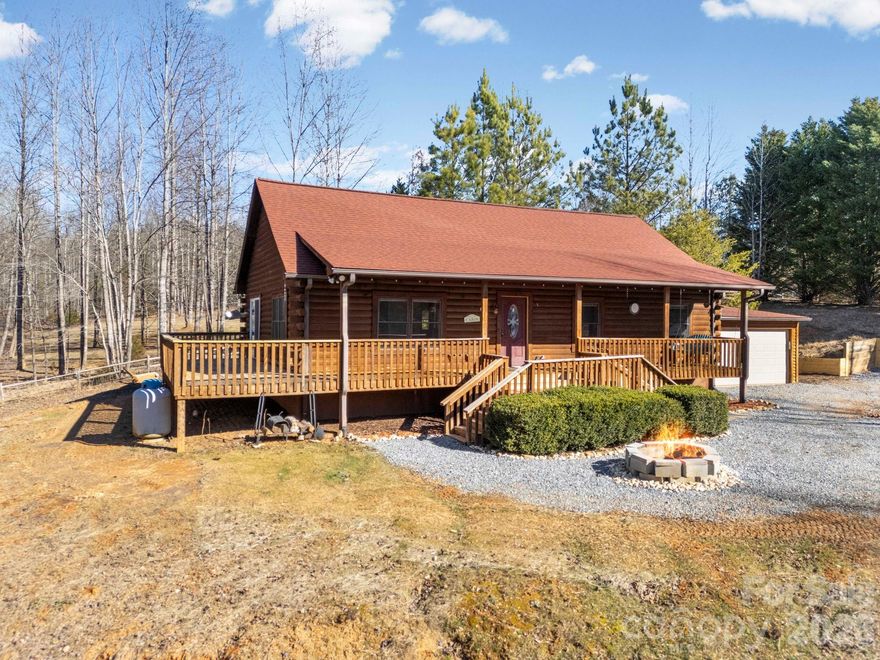 Escape to a peaceful retreat in the glory of the North Carolina Mountains!  This beautifully crafted 3-bed, 2-bath log cabin sits tucked within Clearwater Creeks gated Community and offers the perfect blend of privacy, security, community, and natural beauty.  Step inside to an open floor plan with a stone fireplace in the great room that flows freely into your kitchen and dining area with ample space to entertain. Navigate through glass doors outside to an expansive deck that overlooks the property.  Feel free to let your animals play in the completely fenced in yard and enjoy wildlife in this picturesque setting where you can sit by the firepit with a cup of coffee.  Brand new roof with transferable warranty in 2025.  There is a home warranty until 4/1/2026 which can be renewed.  You can have all of this at a great price and let's face it . . . a setting like this is really priceless!!  Schedule your visit today!