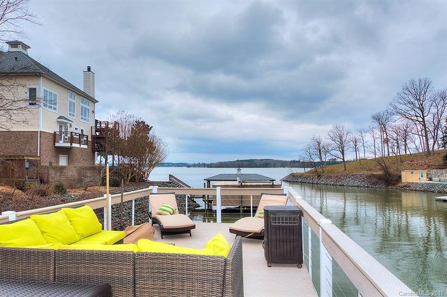 Sought after cove waterfront in Tega Cay! Split bedroom plan with master on main. Master bath has dual sink vanity and whirlpool tub. Finished basement with 2 spacious bedrooms each with own large bath. Bed/bonus on upper level. Huge closets. Upper & lower decks. Basement bedroom with private patio. Steps lead down to double deck boat dock new in 2012.  4000 lb capacity lift. Resort living at its best. Fort Mill schools.