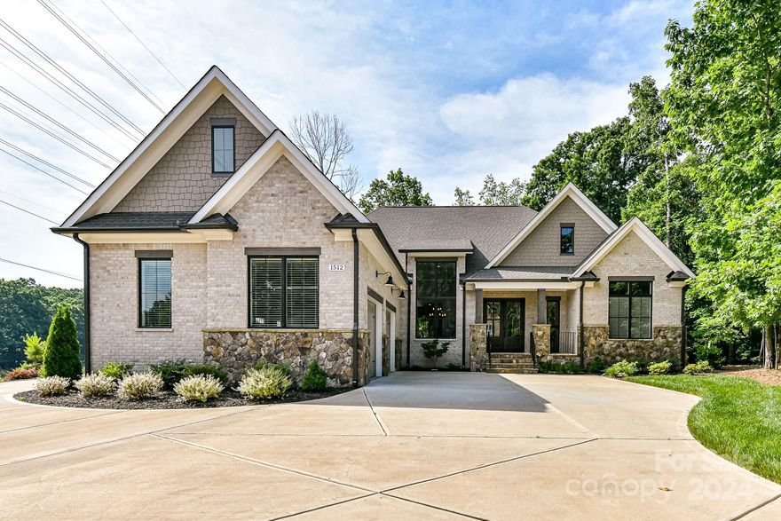 Stunning Custom Built Arthur Rutenberg Plan on Private 1+acre Cul-de-Sac Lot in Gated Community! 2022 built all main floor living & finished bsmt is teeming w/architectural detail & beautiful finishes. Kitchen features tons of cabinets, professional grade 6-burner range & hood, quartzite island/counters & hidden scullery/pantry accessed thru faux cabinet door. Open Great rm features coffered ceiling. Dining area w/soaring window floods home w/natural light. Custom wet bar w/bev fridge & sink. Primary BR at rear of home w/beautiful views of private yard features double tray ceiling & leads to ensuite w/gorgeous tilework, seamless glass shower, soaking tub, dual sink vanity & lrg closet w/custom built-ins. Private office off main living area w/beautiful views. Huge Basement is entertainers dream w/all glass wine cellar & wet bar, workout rm, 4th BR & walkout patio, tons of storage.  Private fenced yard w/expansive views enjoyed from covered porch w/stone gas fireplace & outdoor kitchen.