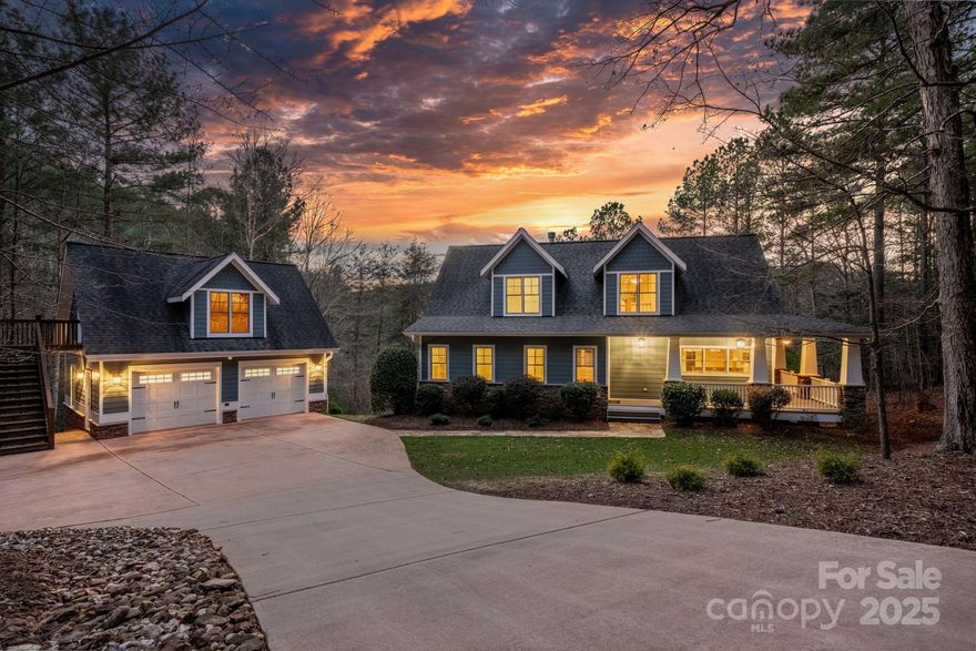 Nestled in the woods down a long driveway, this home has the privacy you desire within a gated community.  The outside appeal with the wrap-around porch (with fans!) is matched by a beautiful and functional interior. Out back there is a very gentle slope to the water - very rare in this area!  The dock has been recently refurbished and includes a boat lift. Sitting on the dock you can enjoy the peace of the large cove while watching the sunset. There is a small marina just a few minutes away by boat to refuel your tank. Now, back to the house - the open floor plan includes a two story ceiling in the living room which has direct access to a large, very well-maintained deck.  The primary bedroom en-suite also has direct access to the deck. Your favorite spot on this main level might just be the screened porch, which looks out over the wooded yard to the lake.  Upstairs are two large bedrooms with a full bathroom.  The large, walk out basement can be whatever you need it to be; there is a very spacious main room, a separate room (which is flex space), and a full bathroom as well.  Additionally there is some unfinished space which is currently being used as a workshop.  (Back on market - buyer changed mind due to personal reasons)
   Looking for storage? The oversized 2 car detached garage  easily fits large cars/trucks, and it has a clean and open upstairs area for tons of storage, accessible by a full staircase. THIS is the lake home you have been looking for! Reach out for a showing!