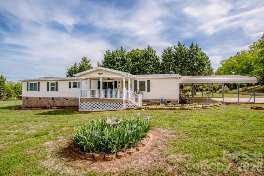 This charming, well-maintained and inviting 3-bed, 2-bath home sits on a private paved road and offers the perfect balance of comfort, style, flexibility and storage. The open-concept layout creates an effortless flow for everyday living, comfort, space and entertaining, with bright, connected areas that make the home feel welcoming from the moment you enter inside.

A spacious bonus room with a full closet adds valuable versatility ideal as a guest room, media room, or hobby area and the additional flex room off of the primary suite functions beautifully as a home office, nursery, den, sitting room or home gym giving you room to adapt as your needs evolve.

Thoughtful details continue outdoors with a covered front porch featuring a ceiling fan, perfect for relaxing mornings or evenings with a cup of coffee, tea or lemonade and the rear deck is ready for gatherings or grilling. 2 large double storage buildings ensure you have space for all your tools, toys, and seasonal items.

This home delivers charm, functionality, and privacy in one well-cared-for package and is ready for its next chapter.