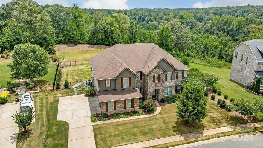 Welcome to 4202 Thames Circle, a stunning 5000+sqft estate backed by green space with direct access to the Catawba River and a community pavilion with a kayak launch. This 5-bed, 3.5 bath home boasts a custom-built resort-style pool with hot tub and full outdoor kitchen. The gourmet kitchen features a Calacatta Gold Extra marble island, quartz counters, marble tile backsplash, white shaker cabinets, a gas cooktop, double ovens, and a walk-in pantry. The floor plan includes a large private study and flex/bonus space on the main floor. Upstairs, you can find a spacious primary bedroom with a custom walk-in closet, 4 secondary rooms (2 oversized), and a large bonus loft area. Hardwood floors adorn the main level, stairs, and primary bedroom. The premium fenced lot offers serene views of the Catawba River. Additional features include an oversized 3-car garage, whole-house filtration system, freshly painted exterior, and Energy Star certification with spray foam insulation. MOVE-IN READY!