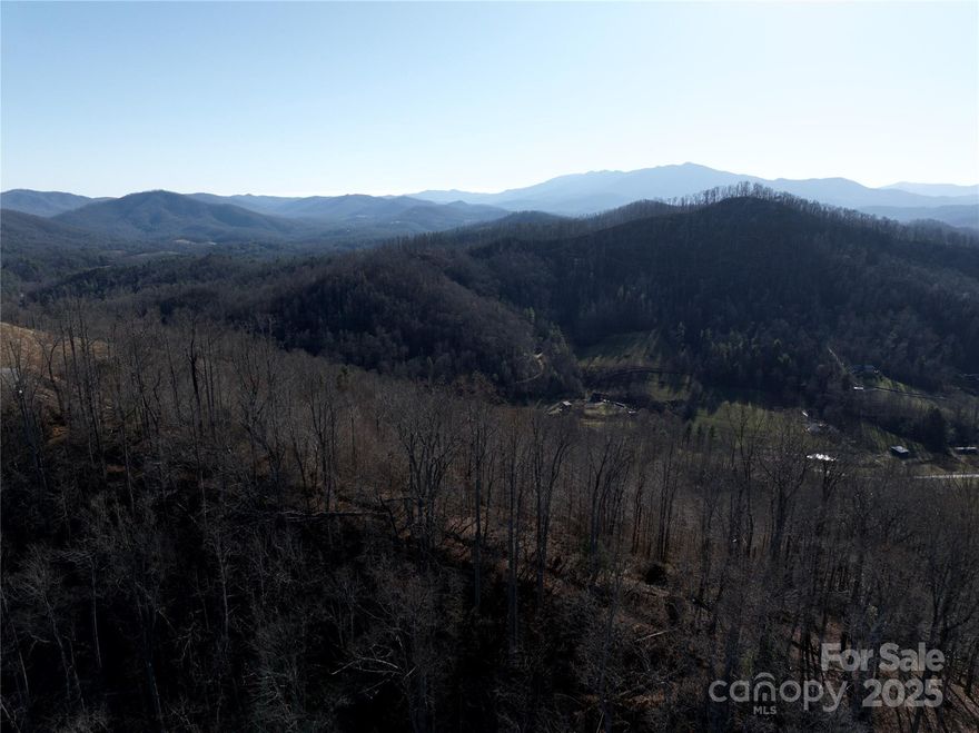 Tucked just off  White Oak Road in Bakersville, this property offers 20+ acres of gently rolling to sloping mountain land with  long-range views that expand the higher you go. Whether you’re dreaming of a private mountain retreat  or a small homestead, this tract gives you room to spread out and truly create something special.

At the heart of the property sits a classic farmhouse—a sweet reminder of days gone by. She did take a hit during Hurricane Helene when a tree came down, but for the right buyer, she could be a charming fixer-upper with a comeback story.

If you’ve been waiting for land that offers story, setting, and serious potential, 615 Fred Sparks Road is ready for its next chapter. Come walk the property, dream a little higher, and see how this Bakersville acreage can become your own mountain legacy.