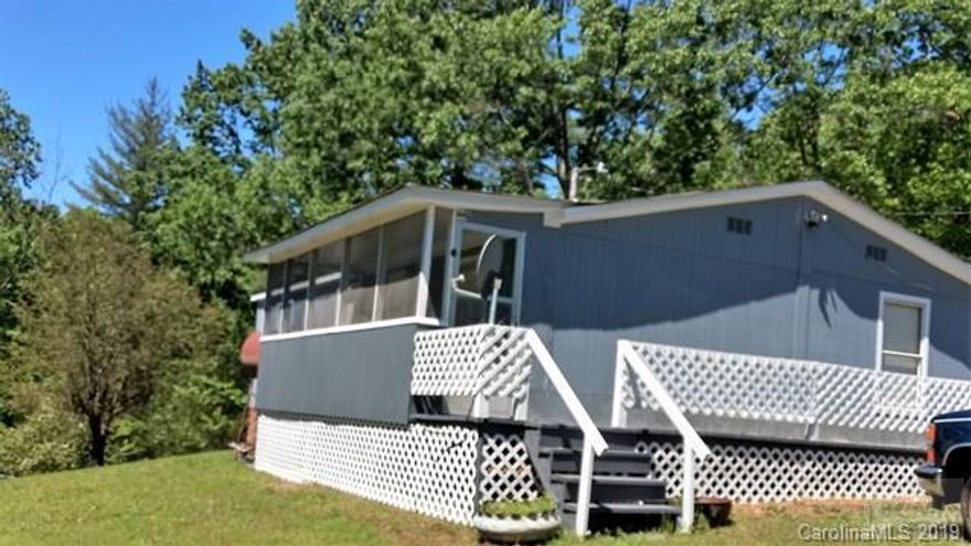 Great starter home or place to retire and put your feet up on the covered porch. Features 3 bedrooms 2 baths on 1.68 acres.  Private with room for kids/grandkids, garden, pets. kids friends, and pets friends.   outbuilding,