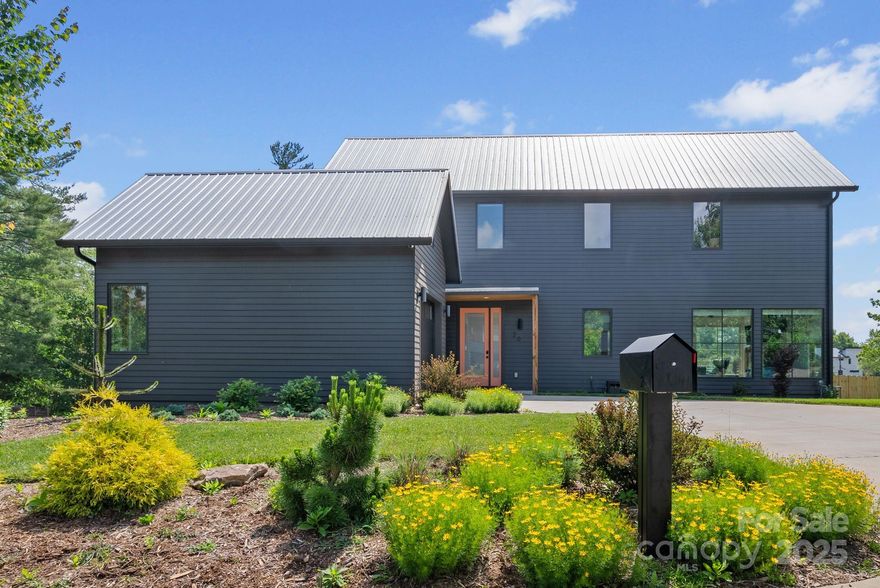 Location, lifestyle, and community—that's what sets this home apart. Malvern Walk is one of West Asheville's most thoughtfully designed low-traffic neighborhoods, featuring sidewalks, and just 30 homes on a quarter-mile closed loop. It offers easy access to both the Hominy and Canie Creek Greenways, encouraging daily dog walks, runs, and evening strolls. Built in 2022, this 4BD/3BA mountain modern home showcases 3/4" solid white oak floors, quartz countertops, shaker-style cabinetry, and oversized aluminum-clad windows. The open main level connects kitchen, dining, and living areas with a gas fireplace, wood mantle, and shiplap accents. A bedroom and full bath on this level add flexibility. Upstairs, the vaulted-ceiling primary suite includes two closets, a walk-in shower, and freestanding tub. The current owner made several upgrades including adding a fenced backyard, stone paver patio, and linear rain garden. A detached garage offers everyday convenience and storage.