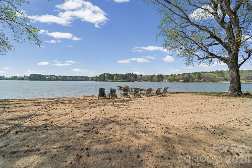 Welcome to your perfect lakefront retreat, offering both upper and lower suites with stunning water views from multiple levels on a double lot. This recently renovated home features a bright and inviting main level with tile floors, exposed beams, and an open-concept kitchen complete with an island and pantry—ideal for entertaining. Enjoy breathtaking lake views from both upper and lower levels, each offering comfortable sitting areas for relaxing or hosting guests. The lower level includes a full bathroom, making it a perfect private suite or guest space. Step outside to a beautiful sandy beachfront, perfect for swimming, sunbathing or enjoying evenings by the water. A volleyball net adds fun for family and friends, while unforgettable sunset views create the ultimate backdrop. Private pier with ladder. The property also includes a detached garage with an attached carport, providing ample space for storing water toys and outdoor equipment; also has water, electric and independent septic already in place. This lake home is ready for full-time living or your next getaway escape.