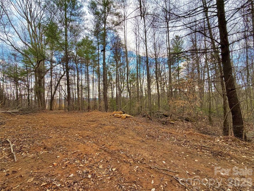 **Ready to Build — Passed Septic Perc Test in Fall of 2025 >> BUY DIRT! 6.31 Acres of WIDELY USEABLE LAND with CLEARED BUILDING SITE & NO HOA! Suitable for Single & Multi-Family development and/or subdivision, this property has great potential for long range southwest facing views of the Blue Ridge Mountains (see winter pics through trees! If you're looking for acreage to build your dream home, then look no further. Reaching approximately 1,150 ft elevation, this mix of gently sloping & level terrain provides a plethora of building sites while also maintaining your ability to subdivide, build additional structures, garden, homestead, or otherwise just enjoy your property. A lot of your pre-construction leg work is already done: Driveway cut in to top of property, Septic Permit pending (already passed perc test), Underground power already on the property, and City of Morganton water available for tap. R-3 Zoning allows for Single-Family, Multi-Family, Duplexes, Modular Homes, Double Wide Homes, & Single Wide Homes. Other allowed uses include: Agricultural, Farm, Mobile Home Park (special use), Churches, and more! Excellent proximity to Downtown Morganton and Lenoir. Take advantage of this great opportunity today!