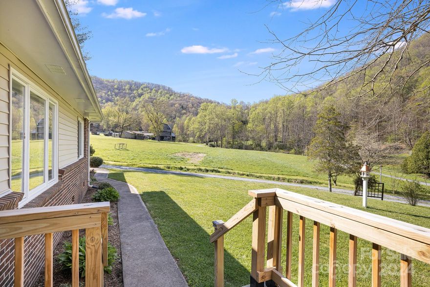 Three-bedroom brick ranch located in the valley of East Alarka, and only minutes from downtown Bryson City. Built in 1979 and located in a great neighborhood, this well-maintained home offers a large eat in kitchen, formal dining room, family room with wood burning fireplace, spacious bedrooms, and plenty of space for storage. Many updates have been added including a new HVAC with transferable warranty, new paint throughout the home, new decking (front and rear), new water heater, and renovated bathroom in the owner suite. The exterior of the home features a flat open yard, two car garage, large patio deck and large open workshop. A small creek runs by the driveway, adding to the extensive character and charm of this home. Fully furnished with some exclusions. Property is unrestricted and can be used as a rental if desired.