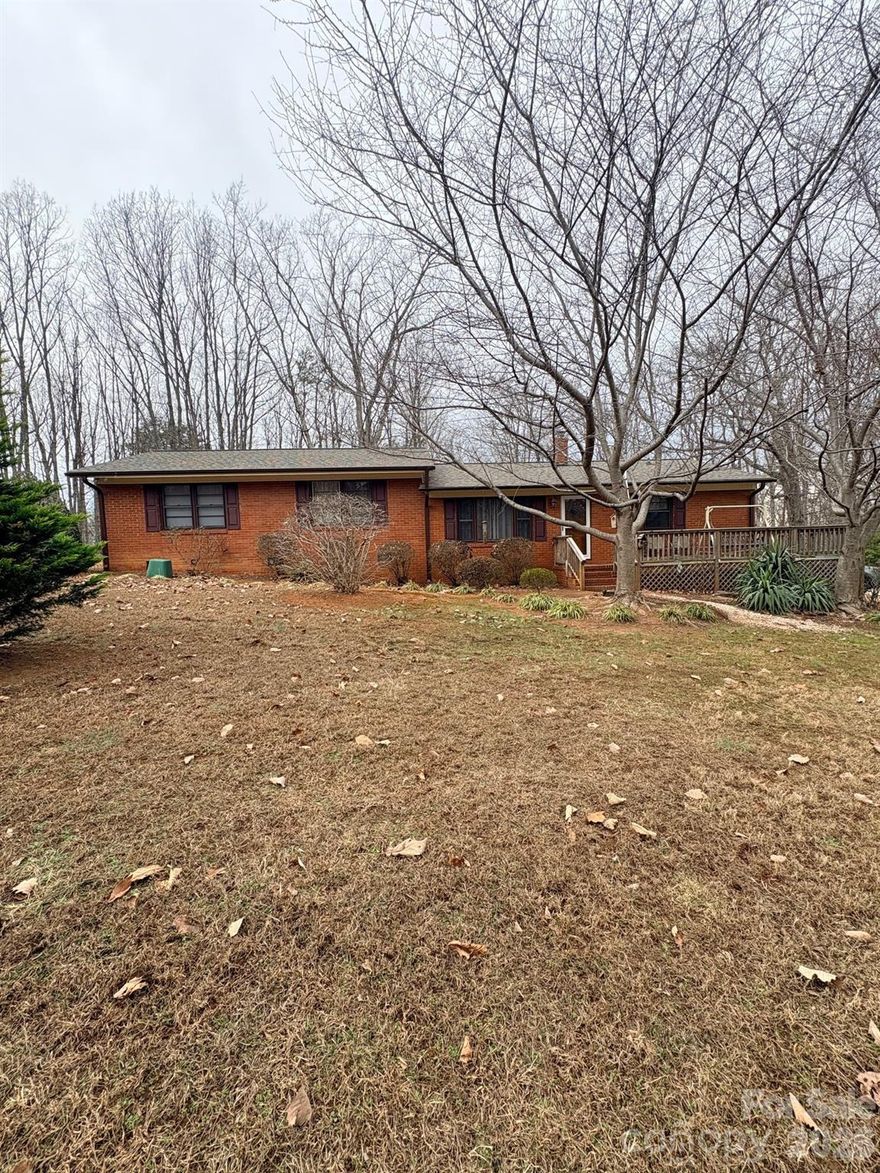 Great opportunity in this sprawling 4 bedroom, 2 bath, all brick home, on 1.32 acres! Originally built in 1963, the Main Level features 3 Bedrooms, Living Room (now used as the Dining Room), and Kitchen with a small Dining Area. In 1969, the Upper Level was added, featuring a huge Primary Bedroom with Ensuite Bath and Walk in Closet and spacious Family Room. The two levels are separated by 4 steps, which transformed the original Ranch home into a Split Level. Kitchen includes a wall oven, electric cooktop, exhaust fan, refrigerator. Laundry is located in the Kitchen, typical of homes built in the 60s. The home has been well maintained overall. In 2022, a new roof, guttering and deck were added, ductwork was cleaned, and floor vents replaced. New 14 SEER, 3 Ton HVAC (inside and out) was installed in 2018, and carries a 10 year parts warranty. Home needs some TLC, including floor covering, interior painting, trim and sheetrock work, and updating. Both baths are in very good condition, although Primary Ensuite Bath is dated. Concrete block storage building needs some work. Fenced dog lot and brick cook pit convey. Home is served by a private well and septic system. Septic drain field replaced in 2010. With a little work, this home could become a showplace! Refrigerator, washer, and dryer convey, although not warrantied. Sundial Lane serves as the driveway to this property, leading to the parking area for this home, and provides a right of way for a few homes that sit farther back in the woods. This property is the perfect ‘sweat equity’ opportunity, as the sellers have taken care of the expensive structural and mechanical updates, leaving the fun and creative renovation projects for the new owner!