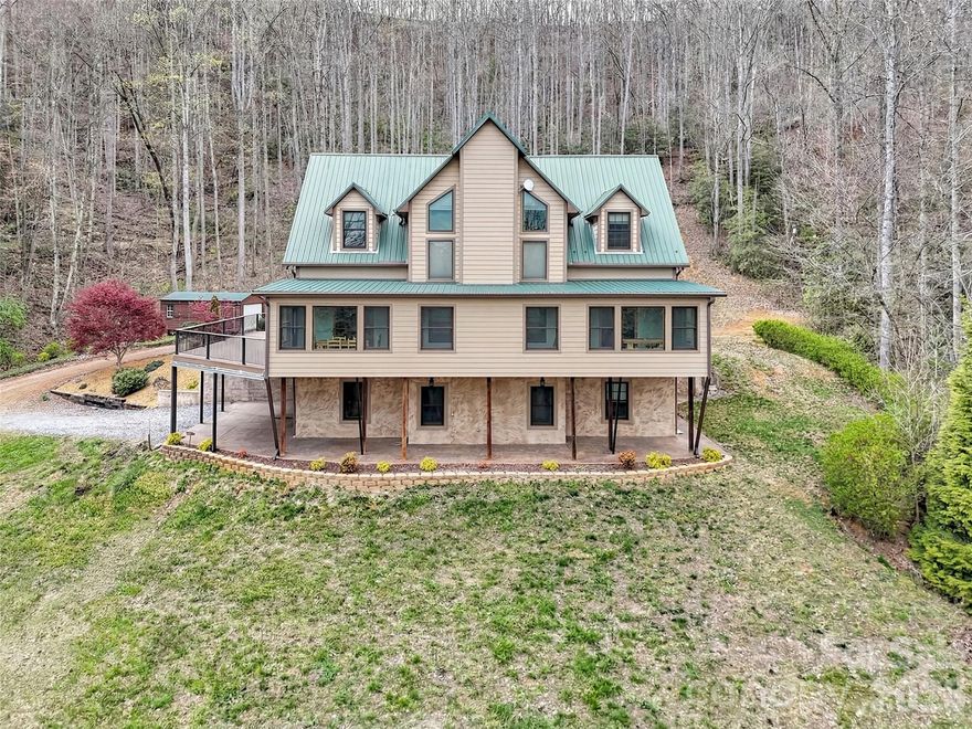 Imagine waking up to long range mountain views, fresh air, and total privacy on 3.66 unrestricted acres. This custom 4 bedroom mountain retreat in Sylva delivers 4,605 square feet of modern mountain design with luxury rustic finishes and flexible living space built for comfort and opportunity. Large windows fill the home with natural light while two fireplaces create a warm, inviting atmosphere. The main living area opens to a massive Trex deck made for entertaining, with a covered patio below that extends outdoor living year round. The primary bath features a spa style steam shower and jetted soaking tub combo with glass enclosure, body jets, rainfall showerhead, and built in seating for a true at home retreat. A fully finished basement apartment offers ideal space for guests, multigenerational living, or short term rental potential. With year round access, ample parking, and close proximity to Sylva, Dillsboro, Western Carolina University, breweries, dining, the Tuckasegee River, and hiking trails, this property blends peaceful mountain living with everyday convenience. Opportunities like this rarely come available. Schedule your private tour and experience the views for yourself.