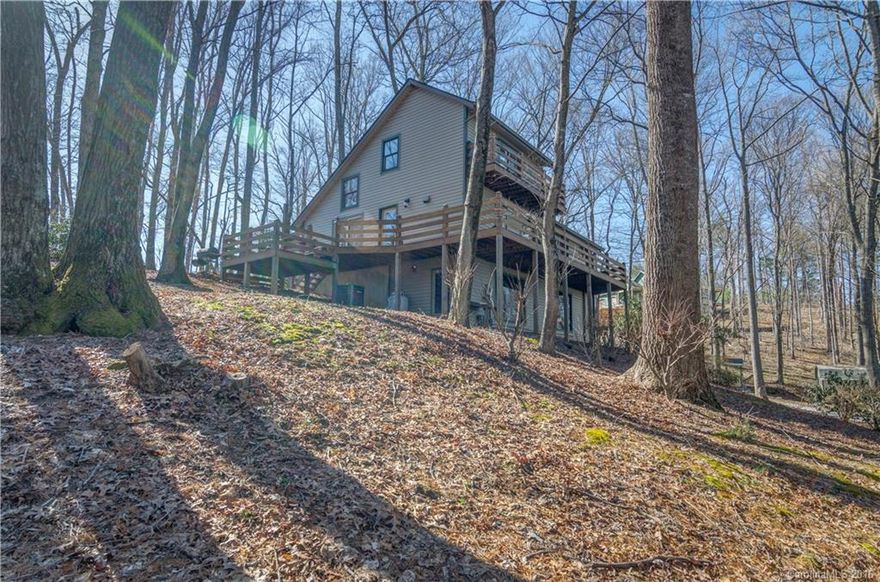 Enjoy the beauty & convenience of Mills River in this lovely & private home on nearly an acre of wooded land. This home boasts beautiful long range views, expansive wrap-around deck, open floor plan, ample storage space in the easy-access attic, & a full unfinished basement w/ double garage. Additional finished room and full bath in the basement. Excellent school districts, proximity to airport, biking, & hiking. Seller is offering $7,000 kitchen remodeling credit. Call list agent to inquire!