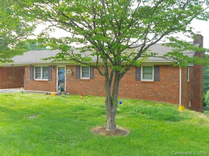 A MUST SEE HOME - 4 BR, 3 bath brick rancher with fenced back yard; additional lot; living room that opens to the Dining Area & Kitchen; long range mountain views; 3 BR and 2 BA on the upper level; a den, and bath on the lower level with gas logs; an attached carport, and concrete drive. Concrete drive also pulls up to the back on home. The bonus feature is a additional room on the lower level which can be used as a game room, the owner used it as a 4th BR. Owner cared for this home and it is reflected in its condition and amenities. For example, the home has a newer heat pump, plumbing, water heater, roof and windows. In an area you'll love (close to Marion, Asheville, and I-40), this is the house you dream of having with very little maintenance and well built. This house also has a security system. Call for your private showing today.