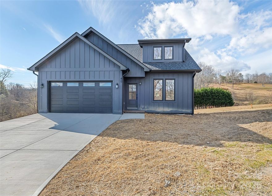 Perched on a peaceful ridge in Alexander, this beautifully appointed 3-bedroom, 2.5-bath mountain home offers exceptional privacy, main-level living, and sweeping mountain views. Thoughtfully designed for both comfort and convenience, the open, light-filled layout is ideal for everyday living and entertaining, with primary living spaces positioned to capture the surrounding scenery. The gorgeous chef’s kitchen anchors the home, featuring a massive oversized island, abundant cabinetry, and seamless flow into the main living and dining areas—perfect for hosting and gathering. Natural light and mountain vistas enhance the home’s warm yet refined atmosphere throughout. The spa-like primary suite is located on the main level and serves as a true retreat, offering tranquil mountain views, a luxurious en suite bath, and generous closet space. Two additional bedrooms provide flexibility for guests or family, while a versatile bonus room is ideal for a home office, media room, or additional living space. A dedicated storage room adds valuable functionality, and the attached two-car garage provides convenience and additional storage. Just a short drive from Asheville, this home delivers peaceful mountain living with easy access to dining, shopping, and outdoor recreation.