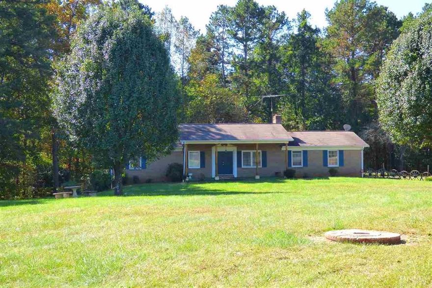 This is the one you have been waiting for! 15.5 Acres of land, house, and workshop! The three bedroom house offers a large covered front porch, den with fireplace, eat-in kitchen with all appliances, huge laundry room/pantry, and three bedrooms, one with private bath. The partially finished basement has a den, bonus room, and half bath. Ceiling height in basement is too low to be considered heated square footage. Main level double garage, basement level single garage. 1414 Square Foot detached storage building. Sold in "as is" condition. Priced well below tax value for quick sale.