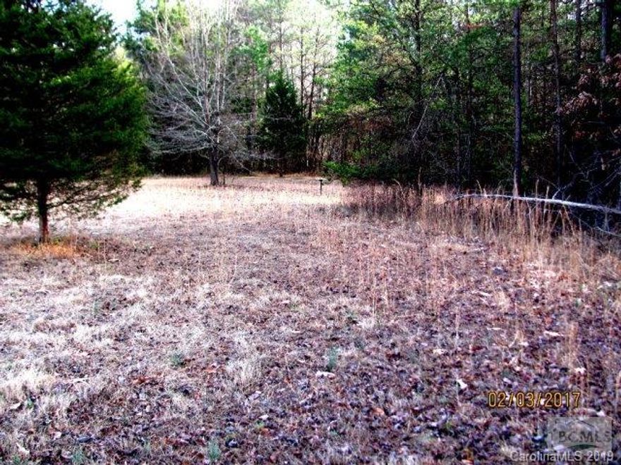 Great one acre lot located on dead end street right in Drexel.  Feels like your in the Country.  Land previously had a mobile home on it so there is a water tap at road and sewer. Gravel drive nice level lot with mature landscape and woods border back of property.  There is a railroad track that backs up to property and railroad has right away across back of property.  Cannot be seen because of wooded area.  This is a great lot and won't last long at this price. RESTRICTIONS:Right of Way