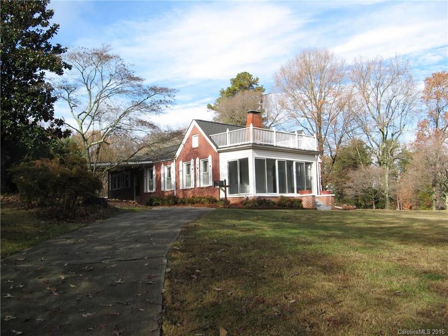 The OVERSIZE lot make a wonderful setting for house. This house has character and charm, just waiting for you to add your personal touches to make it your home. Hardwood floors throughout, except the kitchen and bath.  The living room fireplace is furnished with gas logs. From the living room, era glass pane doors open to the den, which could be a family room, office, study, or adapted to your desired use. 1.78 acre lot provides many possibilities.  Driveways enter from main and side road.