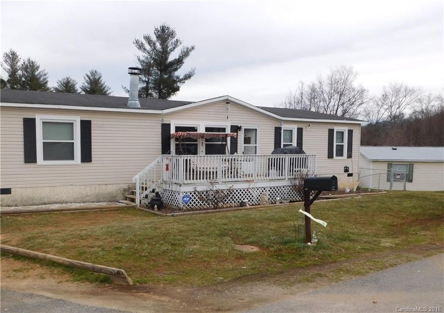 Updated manufactured home on corner lot in quiet neighborhood. 15 minutes from Asheville. Mostly level, gently sloped fenced yard with Garden/storage shed included. This clean, well-kept home has updated laminate flooring, all windows were replaced, New fireplace in LR and paint. Nice, big front & back decks great for entertaining or relaxing. Kitchen Island. 3 bedrooms, 2 bath and a Bonus room that can be used as an office. Great, quiet location just 15 mins to downtown. Must see!