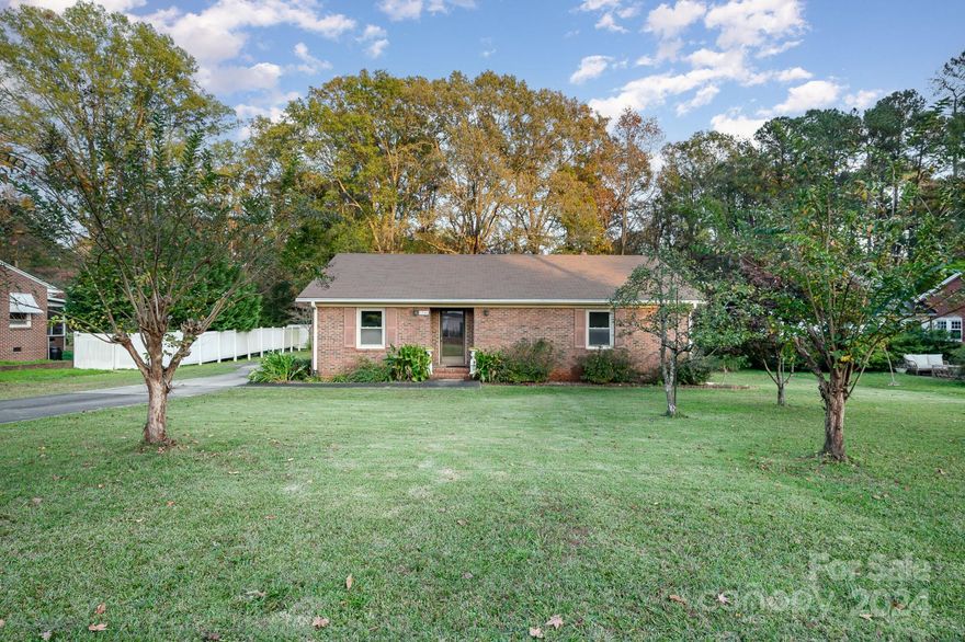 Welcome to 1534 India Hook Road in Rock Hill! This delightful single-story brick home offers 2 bedrooms, 2 bathrooms, and a cozy den with a fireplace, all complemented by beautiful hardwood floors in the main living areas. The attached carport includes a handy storage room, while an additional exterior shed provides ample space for tools and equipment.

Nestled on a generous .57-acre lot, this property is perfect for enjoying the outdoors, gardeners, or relaxing with wooded views. Upgraded with a tankless water heater adds a touch of modern convenience to this solidly built home. Ready for your personal touch, the interior offers endless potential to make it truly yours.   Great for a first time home buyer with a vision or a savvy investor!

Conveniently located near shopping and dining, this home is a must-see. Schedule your tour today!