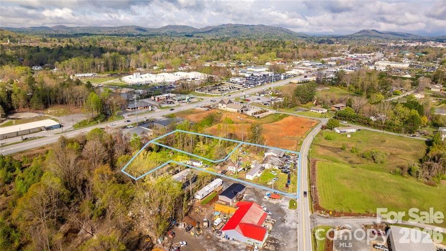 Presenting a versatile commercial investment opportunity at 1611 Old Spartanburg Road and 48 Heavenly Valley Lane in Hendersonville, NC. This combined 1.66-acre property encompasses two parcels with dual addresses, offering a mix of retail and residential income potential. The 1611 Old Spartanburg Road parcel features a 1,360-square-foot building currently utilized as an automotive repair shop and six mobile home pads. This site is well-suited for various commercial uses and benefits from its strategic location along a high-traffic corridor, providing excellent visibility and accessibility. Adjacent to this is 48 Heavenly Valley Lane, a vacant commercial lot on approximately 0.71 acres. This setup offers steady rental income and the potential for future development or expansion. Situated just minutes from downtown Hendersonville and in close proximity to Spartanburg Highway, this property offers a unique blend of commercial and residential opportunities.