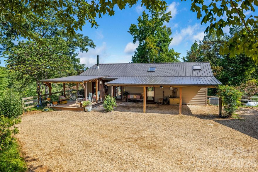 Perched on 25 acres combining wooded areas and two cleared pastures with plenty of space to expand, this custom retreat is built for people who live outside. A private half-mile winding drive leads past a 60' x 40' workshop with an efficiency apartment, before continuing to the main house with sunset views. - Your perfect base camp after a day in the saddle or hiking on the trails.

Step inside and you’re greeted by open ceilings lined with pine tongue-and-groove boards, hand-hewn oak beams, and an artful wood stove surround. The open floor plan invites gatherings, while the main-level primary suite offers a walk in shower with new countertops and sinks. Every detail, from boot-friendly entrances to gear-ready storage, is designed for life lived in muddy boots and trail dust. Year-round and winter mountain views frame the backdrop.

 
Built for Horses, Trails & Creativity close proximity to FETA trail access and all within 12 mins to Tryon International Equestrian Center, 20 mins to Lake Lure, 1hr to Greenville or Asheville and less than 2 hrs to Charlotte.

-Two fenced in pastures (approx. 6 acres) with a custom two-stall stable and tack room — perfect for daily turnout or trail horses.
- Recently installed 190'x 85' arena below main house pasture.
- 2 Run-ins
- Loop trail that crosses a small creek around the perimeter of property suitable for Horse Riding/ Hiking.
- A 60' x 40' workshop - a dream space for additional horse stalls /tack storage, woodworking, welding, or ATV maintenance — with an attached apartment for guests or multigenerational living.
- Two separate living spaces — great for full time living, visiting riders, or potential seasonal rental income.

 Recent Upgrades:

-All-new double-insulated windows (Sept. 2025)
-High-efficiency HVAC system (Sept. 2025)
-New tankless hot water heater
-Expanded Septic Field for the main house and separate septic system for garage apartment on file with Polk County

-Unpermitted, finished storage space above garage/ carport. 

This isn’t just a house — it’s a working mountain hideout, a gathering place for riders, makers, and adventurers. Whether you’re training horses, building gear, or hosting friends, this property is ready for it all.
