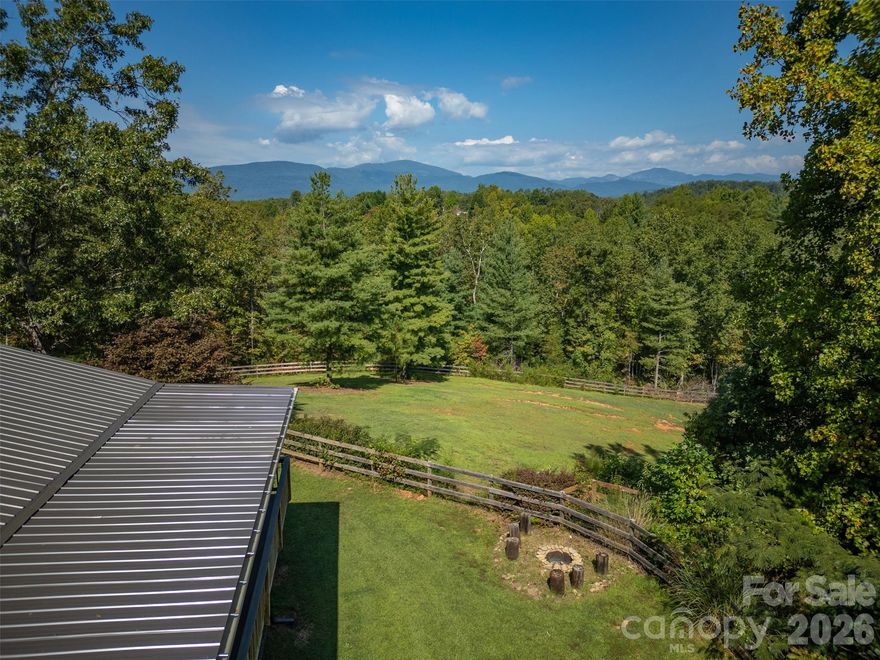 Horse property in Polk County perched on 25 acres combining 2 fenced-in pastures with plenty of space to expand, this custom retreat is built for people who live outside. A private, half-mile winding drive leads past a 60' x 40' workshop with a wonderful apartment for visiting family, friends or Short Term Rentals, before continuing on to the main house with long range mountain views. - Your perfect base camp after a day in the saddle or hiking on the trails.

Step inside and you’re greeted by open ceilings lined with pine tongue-and-groove boards, hand-hewn oak beams, and an artful wood stove surround. The open floor plan invites gatherings, while the main-level primary suite offers a walk in shower with all new countertops and sinks. Every detail, from boot-friendly entrances to gear-ready storage, is designed for life lived in muddy boots and trail dust. Year-round and winter mountain views frame the backdrop.

 
Built for Horses, Trails & Creativity with a private 1/2 mi. trail on property, close proximity to FETA trail access and a new 5 mile Polk County Mountain biking trail, all within 12 mins to Tryon International Equestrian Center, 20 mins to Lake Lure, 1hr to Greenville or Asheville and less than 2 hrs to Charlotte.

-Two fenced-in pastures (approx. 6 acres) with a custom two-stall stable and tack room — perfect for daily turnout or trail horses.
- Recently installed 190'x 85' arena below main house pasture.
- 2 Run-ins
- Loop trail that crosses a small creek around the perimeter of property suitable for Horse Riding/ Hiking.
- A 60' x 40' workshop - a dream space for additional horse stalls /tack storage, woodworking, welding, or ATV maintenance — with an attached apartment for guests or multigenerational living.
- Two separate living spaces — great for full time living, visiting riders, or potential seasonal rental income.

 Recent Upgrades:

-All-new double-insulated windows (Sept. 2025)
-High-efficiency HVAC system (Sept. 2025)
-New tankless hot water heater
-Expanded Septic Field for the main house and separate septic system for garage apartment on file with Polk County

-Unpermitted, finished storage space above garage/ carport. 

This isn’t just a house — it’s a working mountain hideout, a gathering place for horseriders, mountainbike riders, makers, and adventurers. Whether you’re training horses, building gear, or hosting friends, this property is ready for it all.
