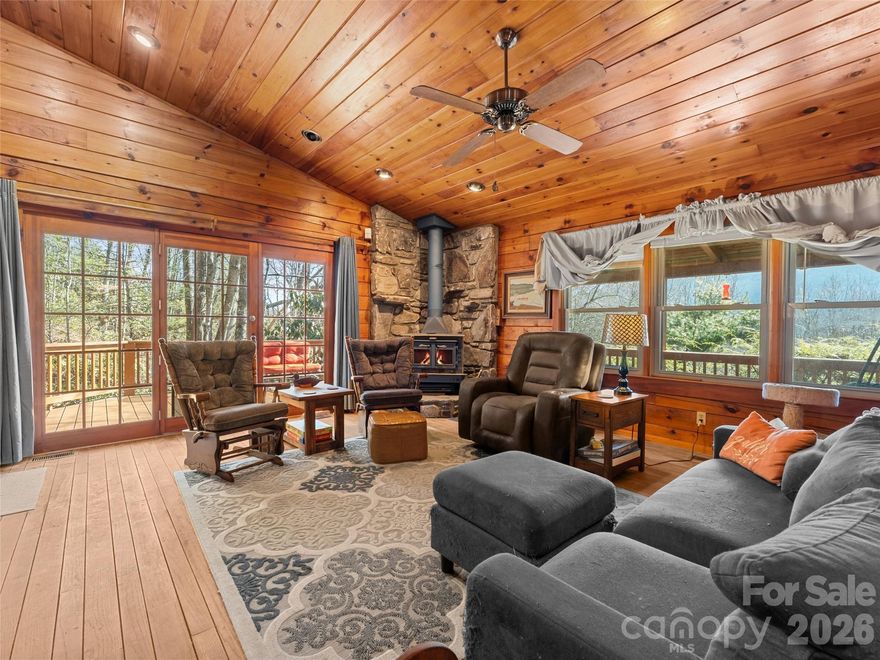 ***Open house POSTPONED until SUNDAY MARCH 1st 2-4PM***  Tucked away in the scenic mountains just above Maggie Valley Club & Resort, this charming single-level log cabin offers the perfect blend of rustic character and modern convenience. Enjoy stunning SSE mountain views and the soothing sounds of the creek below from the expansive wraparound composite deck—both covered and open—ideal for morning coffee, outdoor dining, or simply soaking in the peaceful surroundings. Inside, vaulted ceilings highlight the spacious great room, creating an airy, inviting atmosphere centered around comfort and connection. Officially a two-bedroom home, the flexible floor plan lives like a three-bedroom, offering additional space for guests, a home office, or hobby room. A two-car attached garage provides ample storage and workshop potential, while the publicly maintained paved road ensures easy, year-round access. With high-speed Spectrum internet available, you can stay connected while enjoying the serenity of mountain living.