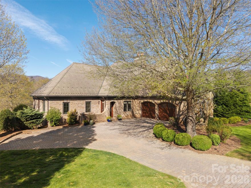 Experience the pinnacle of European-inspired luxury in this stunning duplex home, perfectly positioned on the 9th hole of the Jack Nicklaus Signature Golf Course within the prestigious Fairway Commons neighborhood of the Cliffs at Walnut Cove. This Tuscan-influenced residence offers the effortless lifestyle and convenience of a townhouse while enjoying the expansive scale and benefits of a large single-family home, boasting soaring 10 to 14-foot ceilings, massive picture windows, and custom lighting throughout.  The spacious open floor plan is anchored by a gourmet kitchen featuring a premium Viking appliance package, a dedicated wine cooler, and a striking center island that serves as a focal point for social gatherings. High-end Pella windows and doors frame breathtaking southwesterly views of the manicured greens and the tranquil sounds of a nearby waterfall.  The main level is designed for sophisticated comfort, featuring a grand living room with a coffered ceiling and a stately fireplace, along with an elegant master suite that serves as a private sanctuary with its spa-like bath and custom walk-in closet. For those working from home, an inviting study/additional bedroom offers a quiet retreat. The lower level expands the living area significantly with an attractive family room, a large bonus room, and three guest bedrooms, each with a generous en-suite bathroom. Outdoor living is equally impressive, with a large covered porch adjacent to the living room equipped with phantom screening, and an expansive patio below, each of which provide the perfect vantage point for viewing the golf course and the surrounding mountains. Practical needs are met by a sprawling two-car garage and a dedicated mechanical room for ample storage.  Life at The Cliffs at Walnut Cove provides a world-class lifestyle centered around the Walnut Cove golf course and facilities, and an 18,000-square-foot wellness center featuring indoor and outdoor pools, tennis courts, and a luxury spa. Residents enjoy access to the award-winning clubhouse and "The Tavern," a vibrant social hub for fine dining and exclusive member events. Bordering the Pisgah National Forest and located just minutes from the Blue Ridge Parkway and the cultural vibrant heart of Asheville, this property offers a rare combination of high-altitude privacy and convenient access to premier amenities. With a membership available, this home represents a unique opportunity to join one of Western North Carolina's most sought-after communities.