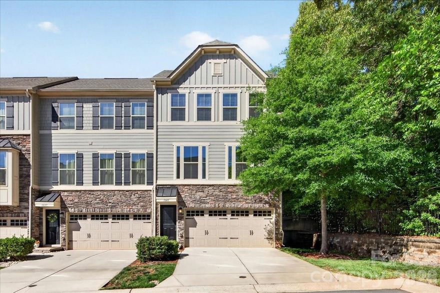Welcome to this exceptional end-unit townhome in the quaint community of Townes at Oakhurst, offering low-maintenance living with 3 bedrooms and 2.5 bathrooms. Situated at the end of the street, this home provides enhanced privacy and a peaceful setting. Spanning three stories and approximately 2,410 square feet, this thoughtfully designed townhome offers a modern, spacious, and functional layout. Lovingly maintained by its original owner, the home has also been freshly painted in a neutral color palette.

Upon entering the lower level, you’ll find a versatile flex space with hardwood flooring ideal for a home office, gym, media room, or additional entertainment area. This level also provides access to the outdoor living space, a large storage closet, and the attached 2-car garage.

The main floor showcases an open-concept layout with hardwood flooring, boasting a bright and airy kitchen, a spacious living room, dining area, powder room, and doors leading to deck perfect for grilling with convenience of a gas line for outdoor entertainment and relaxation.

The gourmet kitchen features a GE stainless steel appliances with gas range, elegant white linen 42-inch cabinetry, iced white quartz countertops, a spacious center island with seating, under-cabinet lighting, brushed nickel fixtures, tiled backsplash, and pantry. Kitchen upgraded with a built-in coffee/beverage station featuring custom cabinetry, glass-front display cabinets, and additional storage.

The upper level hosts the owner’s suite with tray ceilings, a walk-in closet, and a luxurious en-suite bath complete with a garden tub, double vanity, and walk-in shower with ceramic tile surround. Two additional bedrooms share a full hall bathroom, while a conveniently located laundry room completes the upper floor.

Enjoy easy access to Uptown Charlotte along with a variety of nearby restaurants, breweries, and local favorites that create a vibrant, connected lifestyle. Ideally located in the sought-after Oakhurst neighborhood, this home is just minutes from Cotswold, SouthPark, Elizabeth, NoDa, and Plaza Midwood, while tucked within a quiet community setting. Walk to neighborhood favorites like Night Swim Coffee, The Teal Turnip, Jersey Mike’s, Anytime Fitness, pizza shop, nail salon, and more. Common Market is less than half a mile away.