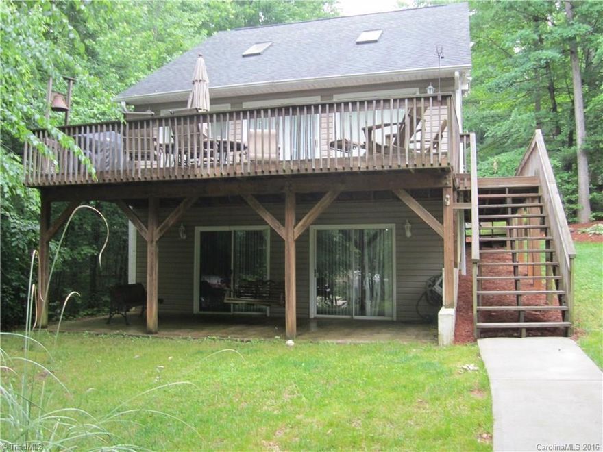 Private lakefront setting on 3.51 acres. Great lakefront home with 3 bedrooms, 3 baths; upgraded kitchen with granite counters, hardwood flooring, pantry - open to dining & living area with access to lakeside deck. Lower level has game room, bath and bedroom for guests, in-laws or teenagers. Nice walkway to lake and storage building for lake toys. Private pier & floater and community boat launch area.