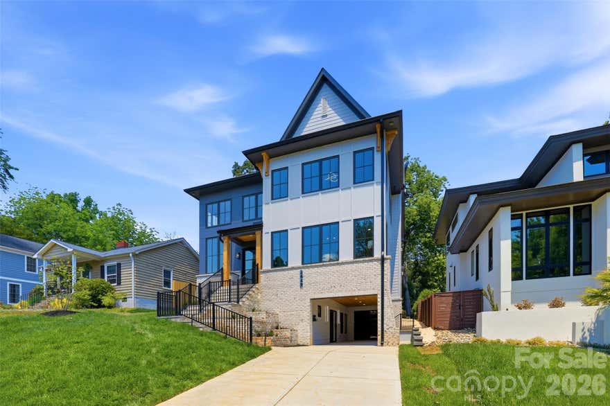 Stunning. Modern. Sleek. Warm. Inviting. 2649 Laburnum Ave is offically fully completed and staged!! This custom new construction home offering 4,255 sq ft of thoughtfully designed living in the heart of Charlotte's beloved Chantilly neighborhood.

Four bedrooms, each a private en suite retreat with a large walk-in closet. Five and a half beautifully appointed baths. Engineered hardwood floors run throughout, grounding every space with warmth and continuity. The open floor plan flows effortlessly, yet every space feels defined and purposeful...nothing lost, nothing wasted.
The main level features custom maple cabinetry, Thermador appliances, quartz countertops, designer lighting and plumbing fixtures, and a sleek linear fireplace. Seamless indoor-outdoor living continues on the screened porch overlooking the walkout basement below.

Spacious. Comfortable. Complete.

Nestled between Plaza Midwood and Elizabeth, Chantilly offers tree-lined streets, friendly sidewalks, sanctuary with a greenway and a community unlike any other — Food Truck Thursdays, holiday markets, and the iconic annual Home Tour included.
