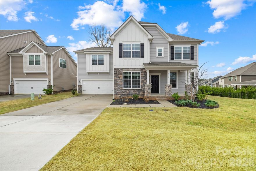 Rare 2023-built home on an oversized 0.35-acre lot in one of Waxhaw's most sought-after communities — zoned for the 9/10-rated Waxhaw Elementary School and move-in ready today.

With over 3,500 square feet across two thoughtfully designed levels, this 5-bedroom, 4.5-bath home delivers the space and flexibility modern families want. The heart of the home is a chef's kitchen built for entertaining — quartz countertops, a large center island, gas range, subway tile backsplash, walk-in pantry, and a seamless flow into the bright family room with gas fireplace. Hosting guests? A dedicated main-floor bedroom with full bath means everyone has their own space.

Upstairs, the primary suite is a true retreat — spacious bathroom, large walk-in closet, and the privacy you've been looking for. Three additional bedrooms, multiple bathrooms, and a generous bonus/loft area give you the flexibility for a media room, playroom, or home office. Laundry is conveniently located on the main level.

Step outside to one of the largest lots in the neighborhood — nearly a third of an acre with real room to breathe, play, and entertain. The covered front porch and attached 2-car garage round out a home that's as practical as it is impressive.

All of this sits inside MillBridge, an award-winning master-planned community in Waxhaw offering resort-style pools, a clubhouse, fitness center, tennis courts, putting green, playgrounds, and miles of walking trails. Freshly painted, professionally cleaned, and priced to move — this is the one you've been waiting for.