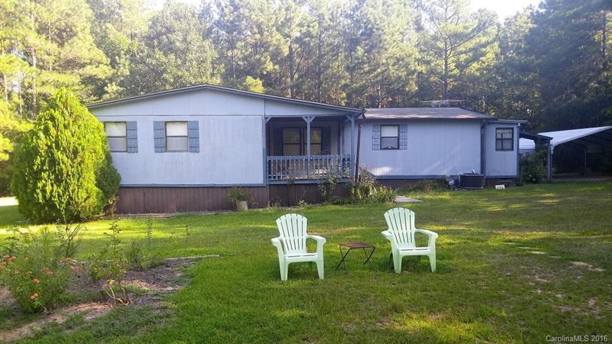 Well Maintained 3 Bedroom/2 Bath Manufactured Home on large level lot in private setting in the Lowrys Community North of Chester, SC.  Large lawn area with home tucked back away from road.  Lot is wooded for most part and surrounded by large parcels for extra privacy.  Home has a large room addition for multiple uses and a front and back storage room addition.  There is a large metal storage building and nice double carport.  Wide front porch provides nice shade from the afternoon sunshine.