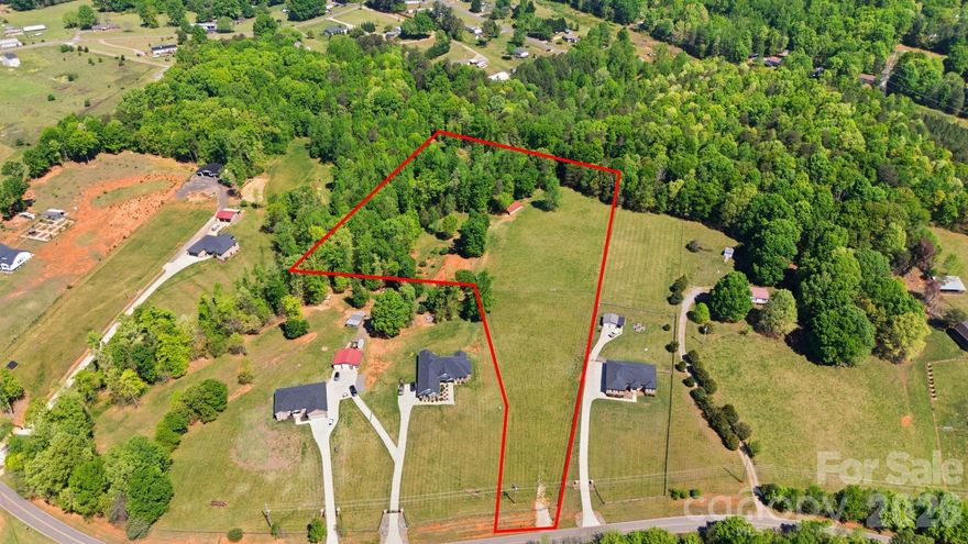 5.918 ACRES | HARD TO FIND | PRIME LAND OPPORTUNITY IN LINCOLNTON, NC | BUILD YOUR DREAM + BRING YOUR ANIMALS.  
LAND IS FULLY FENCED, GATED AND LOCKED. IT IS ONLY ACCESSIBLE WITH A REAL ESTATE AGENT.
Looking for land in Lincoln County that offers freedom, privacy, and long-term value? This 5.918-acre tract (Parcel #109178) sits in a peaceful setting just off Null Rd in Lincolnton, NC, giving you both accessibility and a tucked-away feel.
This is the kind of property buyers wait for.
This property offers nearly 6 acres of usable land, making it ideal for a custom home, mini farm, or private estate. Zoned RR (Rural Residential), it provides flexibility while still maintaining smart protections that support long-term value. You can bring your horses, goats, chickens, and more, making it perfect for a hobby farm or homestead lifestyle. The setting feels private and peaceful, yet you are still conveniently close to town. Inventory like this is limited in Lincoln County, which adds to its strong resale appeal.
When it comes to building, this property is designed to protect your investment. There are minimum square footage requirements and exterior siding standards in place to maintain a clean and consistent look throughout the area. Mobile and modular homes are not permitted, helping preserve the quality and value of surrounding properties and your new home.
Location is another key advantage. You are just minutes from downtown Lincolnton with easy access to Highway 27 and Highway 321. Lake Norman, Charlotte, and other growing surrounding areas are all within a short drive, giving you the benefit of a quiet rural setting without feeling isolated.
This property is well suited for custom home builders, buyers looking to relocate for more space and privacy, those interested in equestrian or hobby farm living, and investors seeking land with long-term upside.
Land like this is moving quickly in Lincoln County. If you have been waiting for acreage that offers both flexibility and standards, this is your opportunity.  Minimum Square ft for single home is 2,000 sq feet, multiple homes is 1,800 sq. ft. Brick exterior.  Please check with the county to see if the property can be subdivided. There might be a possiblity of building 3 homes.  Seller makes no warranties or representations on subdividing.