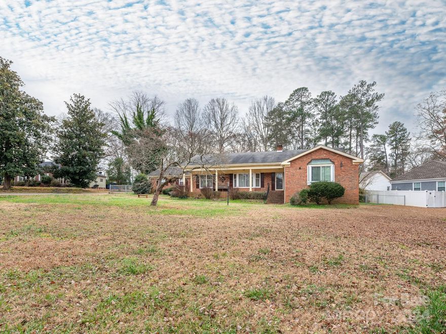 Beautiful brick ranch home w/ basement on spacious private lot. Home includes multiple living areas, 2 bedroom suites, gas focal fireplace, and rear sunroom. Over 3,000 sq ft of living in the quite Spencer Estates community with no HOA! Home is just 2 miles from Downtown Rock Hill and is close to tons of local parks + quick access to I-77 getting you into Charlotte or Columbia with ease. Beautiful curb appeal welcomes you in with a covered front porch, reach porch & a fenced in yard. Second living quarters are perfect for in-law suite or rental opportunity. This includes kitchen & living area, bed & bath w/ walk-in shower + walk-in closet and while accessible through the main house, does have a private entrance from outside. Outdoor yard space is perfect for hosting family or friends plus a spacious detached wired garage/shop for extra storage a home office area. Fantastic property in a great location not to be missed!