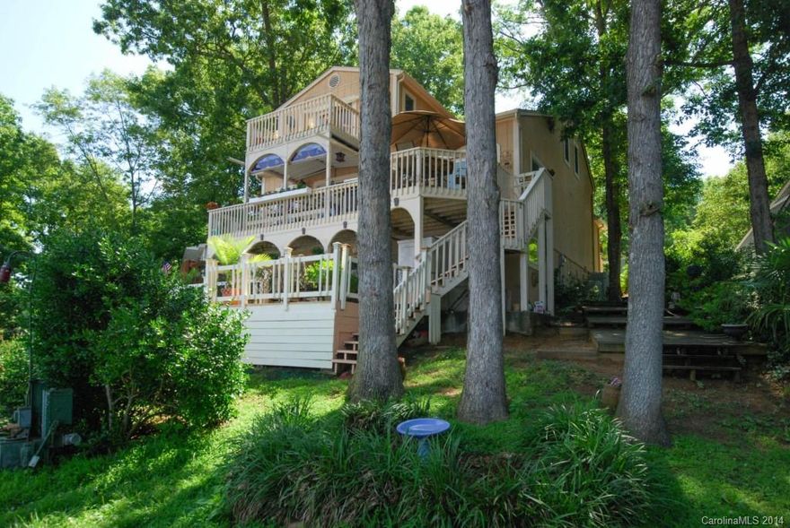 Lake life at its best! This water front home with decks on every level offers beautiful views of Lake Wylie and the marina. This home offers an open floor plan, perfect for entertaining or just getting away. The large master bedroom is on the second floor with great views and lots of closet/storage space. The fully finished basement  features a huge rec room with gas log fireplace, one bedroom and a full bath. Custom stained glass throughout the home will remain. It's a life style, come see!