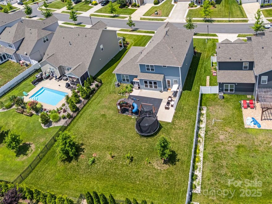 PRICE IMPROVEMENT! This North-facing McCullough home is a show stopper w/ it's dbl front porch & over 1/4 acre lot! As you make your way in on engineered wood floors that run throughout the downstairs common areas. The chef's kitchen is sure to impress w/ wooden hood, gas range, walk-in pantry, & flex w/ built-in drop zone. The open floor plan gives light throughout the extended great room & dining, & rounding off the downstairs is an office w/ french doors, 1/2 bath, AND guest bed w/ full bath. As you head upstairs you'll find a loft, 2 secondary beds & a bath, & primary suite w/ details incl trey ceiling & custom closet. No detail was spared w/ fans in all beds, finished garage w/ epoxy floors, molding details, whole home water softener system, & more! Outside you'll find an expansive patio (over 900 sqft) & large yard! McCullough is a lifestyle rich community w/ 2 pools, courts, dog park, near downtown Pineville, & 10 min from the light rail that takes you to uptown - welcome home!