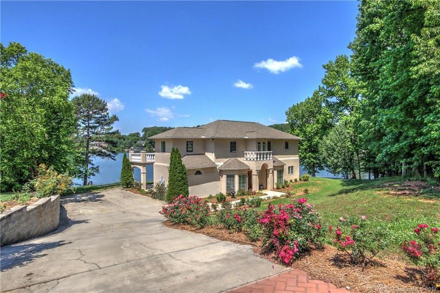Waterfront Lake Norman w/Caribbean style views! Amazing sunsets overlooking main channel. 217 ft of shoreline. The perfect vacation or full-time home. Two kitchens/two master suites/dual laundry. Downstairs kitchen recently upgraded and is just beautiful! Enjoy a glass of wine on the covered lower veranda or above tiled veranda & watch the sun melt away.  Don't feel like cooking - take a ride across the channel to the 150 bridge & have dinner.  So convenient to everything Lake Norman!