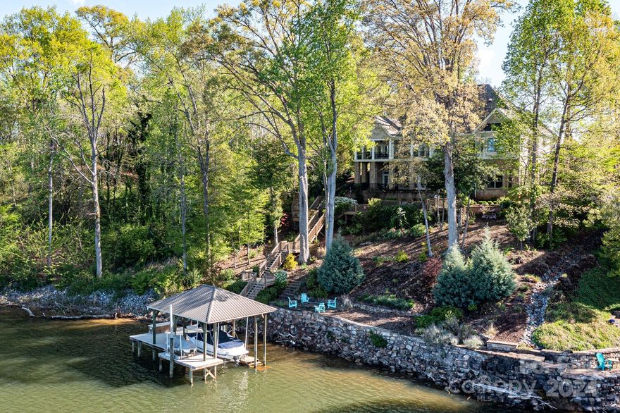 Panoramic sunsets! Enchanted waterfront retreat with sweeping main channel views north and south on Lake Norman! Private island with gated entry! Windemere Island offers a very unique lakefront lifestyle for a private, peaceful and serene living experience! Stunning covered porch to enjoy the western sunsets.  Entertainers' space for interior/exterior events. Stunning 5 bed, 5 full bath! Updated Lower Level is a tranquil retreat of its own! Private covered stationary dock/hoist/lift. Outside shower near exterior fireplace, perfect for your return into the home! 
Extremely well-maintained property with meticulous landscaping, truly a nature-preserve atmosphere. Neighborhood amentities include exterior pool and various clubhouse events, tennis and pickleball courts. Minutes to Lake Norman State Park. A feeling of being on vacation every day for year-around enjoyment!
Check out windemerelkn.com for extensive property infomation. Brand-new roof being installed May 8-10th.