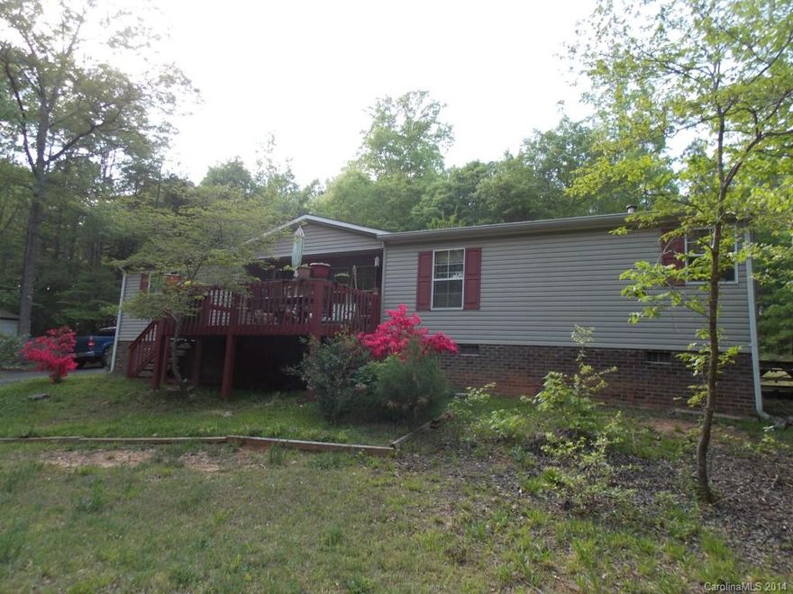 Tranquil three bedroom home on almost three acres of land.  Drive up a winding asphalt driveway to your home nestled within the tree line.  The exterior features a front deck, large paved parking area, and outbuilding adjacent to the driveway.  The home features three bedrooms, two full bathrooms, great room with fireplace, master bedroom with on-suite bathroom, dining room, kitchen with pantry and breakfast table area, and a laundry room off of the kitchen.