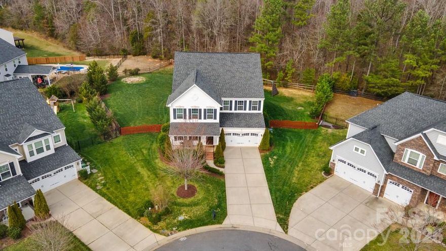 Welcome home to space, comfort, and connection in this beautifully maintained 5-bedroom, 3.5-bath 3-story home offering over 4,300 square feet on a quiet cul-de-sac home-site!

The inviting front porch sets the tone as you step inside to an open, light-filled floor plan designed for both everyday living and entertaining. The spacious great room with fireplace flows seamlessly into the kitchen, featuring a large island, abundant cabinetry, pantry, and an easy connection to the dining area. Whether hosting gatherings or enjoying a quiet evening at home, the layout offers flexibility and function.

The main level includes a dedicated home office and sunroom. Upstairs, the generous primary suite provides a private retreat with a well-appointed bath and walk-in closet. Three additional bedrooms and loft area offer ample space for family or guests, while the third-level bonus/media room and yet another bedroom creates the perfect setting for movie nights, gaming, or a private getaway.

Outdoor living is just as appealing, with a rear deck overlooking the tree-lined backyard and firepit, ideal for grilling, relaxing, or entertaining. The attached garage and concrete driveway provide practical convenience.

Located in a friendly neighborhood with amenities including a community pool, playground, and sidewalks, this home offers the perfect balance of tranquility and accessibility, just minutes from Charlotte, Pineville, and Ballantyne.
