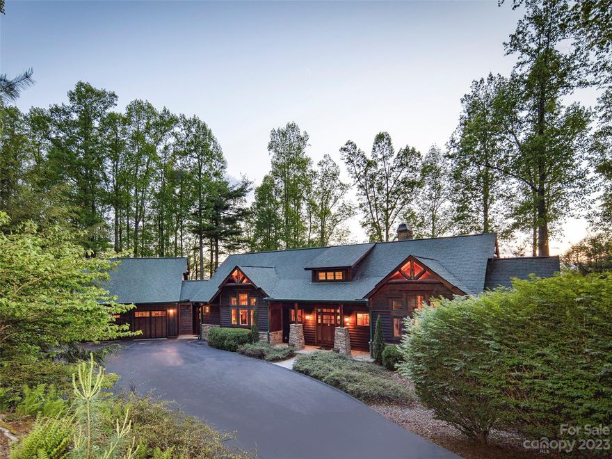 Incredible craftsmanship, long range views of Mount Pisgah and the surrounding Blue Ridge Mountains! Vaulted Great room with custom stone fireplace, hardwood floors, tongue and groove vaulted ceilings, wood posts, and exposed beams. Fabulous gourmet chef kitchen with center island and custom cabinetry, walk in pantry and large drop zone with office space. Luxurious primary suite with separate vanities, custom walk-in closet with full size laundry room. Lower level offers expansive family room with access to lower covered deck,2 guest bedrooms,  craft/sewing room, bonus exercise room and tremendous storage. Private lot with easy level driveway entrance. This light-filled house boasts mountain views from virtually every room and the cozy screened in porch and open deck